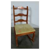 Ladderback bedroom rocker with upholstered seat.
