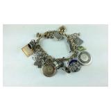 Charm bracelet both gold and sterling charms, 10k