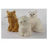 Three ceramic cat statues,  front Kitty has glaze