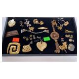Display case of costume jewelry, pens/brooches,