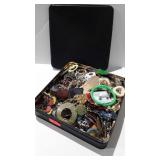 Tin of costume jewelry