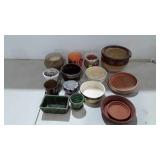 Pottery planter group with a few under dishes
