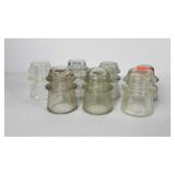 Seven glass insulators, condition as shown,