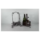 Two metal wine bottle holders and one glass wine