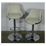 Two chrome based adjustable stools. Seats show a