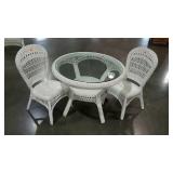 Three piece wicker table and two chairs. Glass