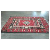 Native design area rug. Red wire black, tan and
