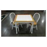 Small tile top kitchen table with two chairs.