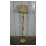 Brass toned floor lamp with fringed shade. 60"