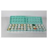 Three dozen used golf balls in egg cartons,
