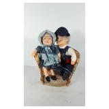 Grandma and grandpa dolls in wicker chair