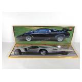Two framed car posters, a Vector and Lamborghini,