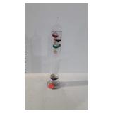 Glass thermometer with floating temperature beads