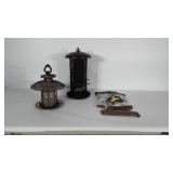 2 bird feeders and a hanging bird sign.