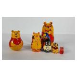 Winnie the Pooh nesting dolls and rolly rattler,