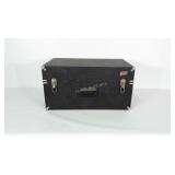 Wooden storage trunk with black vinyl covering.