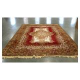 Wool pile area rug with center medallion design.