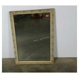 Wall mirror with intricate frame. 23"×33".