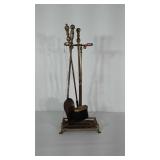 Brass / Brass toned fireplace tools and stand.