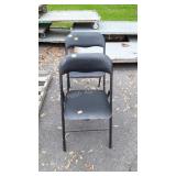 2 black folding chairs