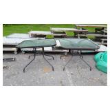 2 patio tables, one is tilted