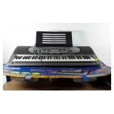 Casio electronic keyboard with box, powers up