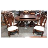 Table with eight chairs and two leaves. Carved