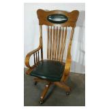 Oak framed rolling desk chair with green