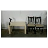 Coffee table and two chairs, table has a mounted