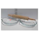 Two glass Pyrex pie pans and wooden rolling pin