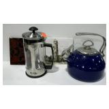 Two ceramic trivets, a tea pot and a Mr. Coffee