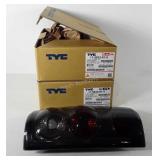 Two 2006 Ford tail lights in boxes