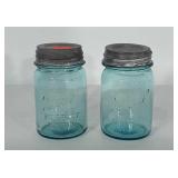 Two blue pint sized Ball Jars with zinc lids.