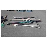 Three sets of skis and two pairs of poles