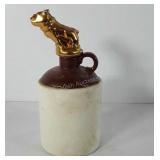 Stoneware whiskey jug with dog stopper