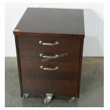 Three drawer office cabinet on caster wheels.