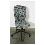 Armless desk chair in geometric pattern.