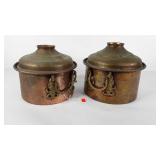 Hammered copper and brass pots with domed lids,
