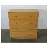 Four drawer laminated chest. Missing one knob.