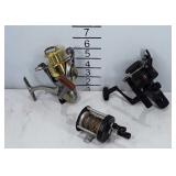 Three fishing reels, Pflueger, Shimano R2000, and