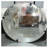 Large, round, beveled mirror on board. Currently
