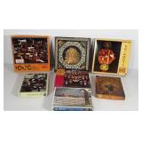 Group of puzzles, all opened, peacock puzzle is