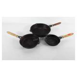 Three cast iron skillets with wooden handles, 7",