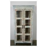 Glass doored cabinet with a distressed finish.