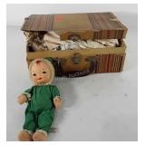 Doll with damaged case full of clothes