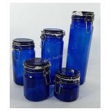 Five cobalt blue glass canisters, 4"-13"