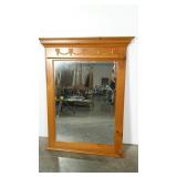 Wood framed mirror with swag and bow appliques.