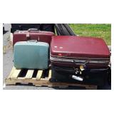 Skid lot of suitcases