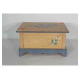 Wooden box with hinged lid. Has floral design
