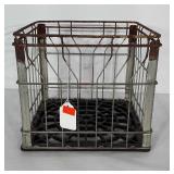 Metal Galliker Dairy crate with plastic bottom.